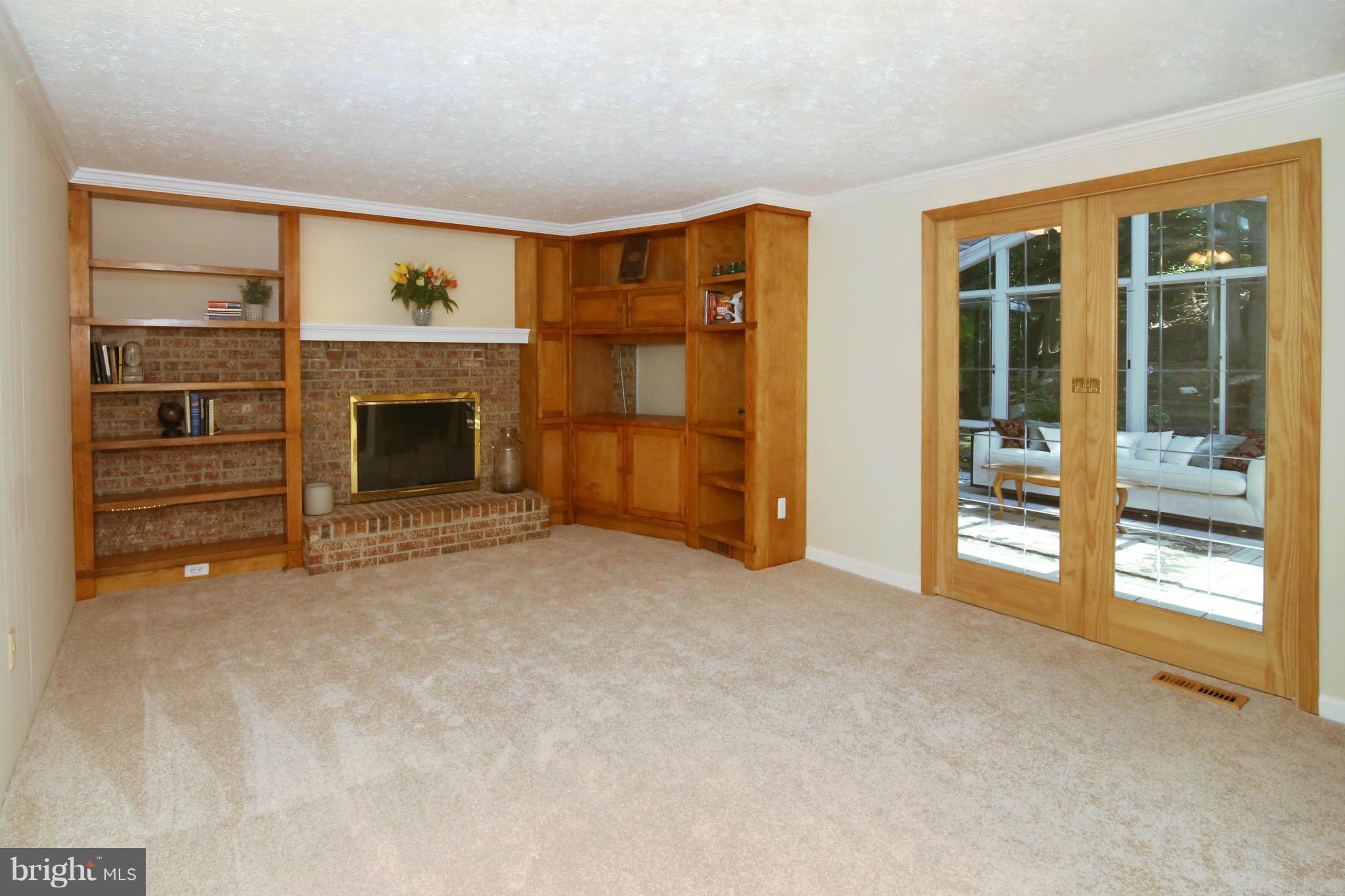 7575 Vogels Way Springfield, VA 22153 - Photo 8 of 30 a view of an empty room with a fireplace and a window