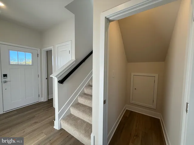 a large kitchen with stainless steel appliances a large counter top a stove and a refrigerator