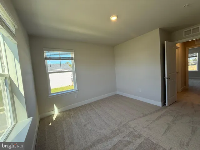an empty room with closet and wooden door