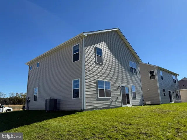 a big house with a big yard and large trees