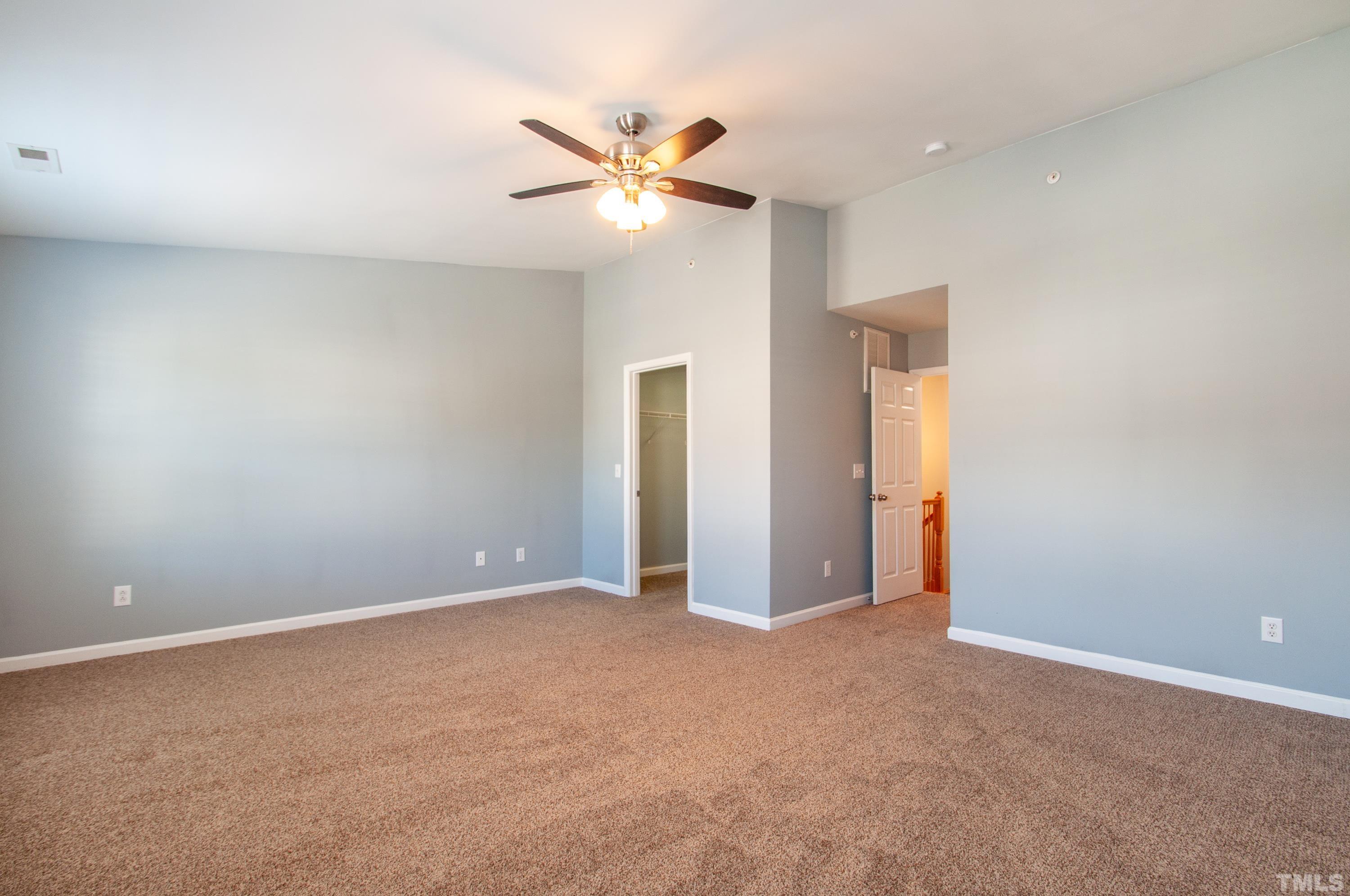 2210 Raven Road, Unit 102 Raleigh, NC 27614 - Photo 11 of 33 a view of an empty room with a ceiling fan and window