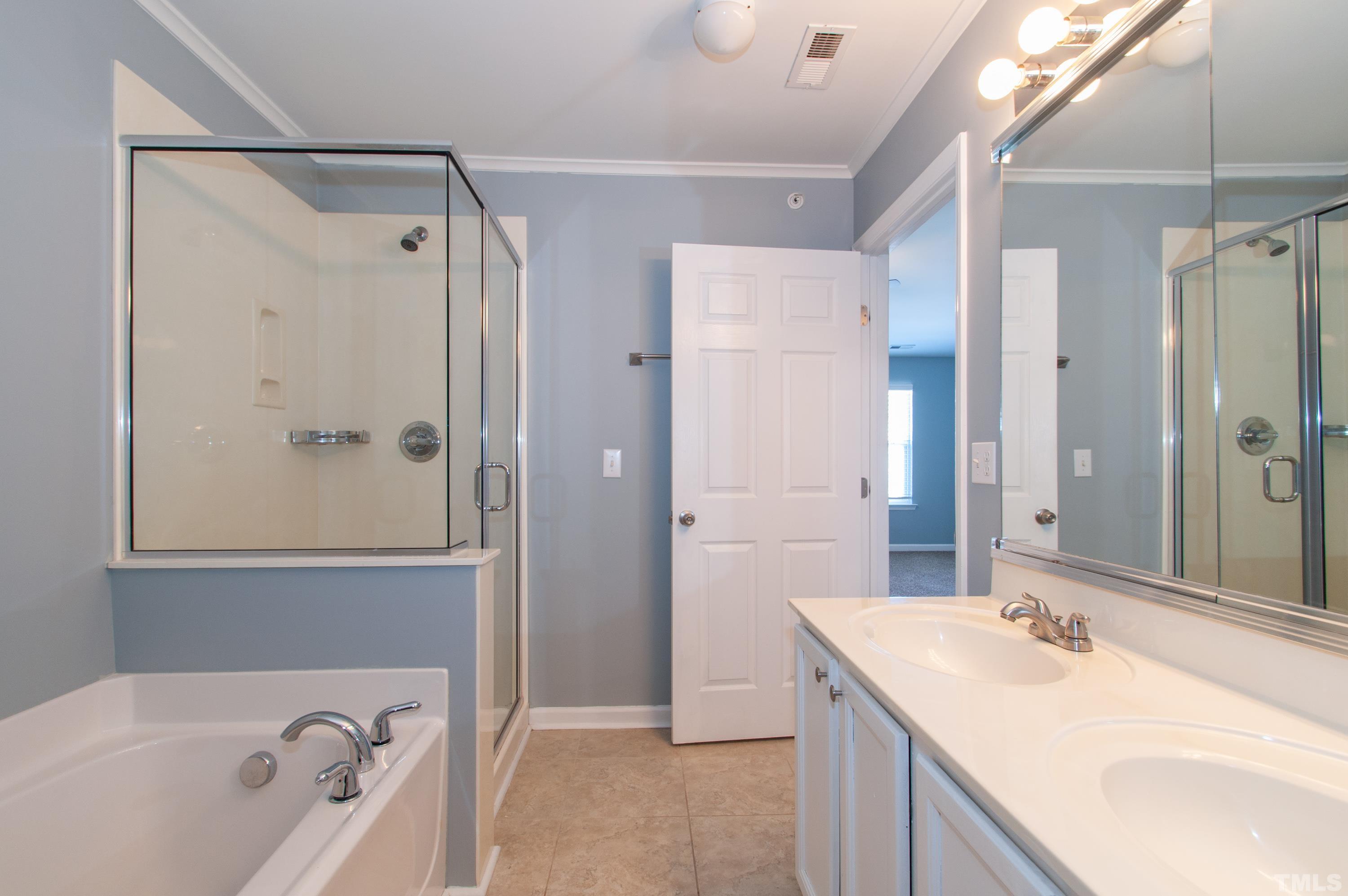 2210 Raven Road, Unit 102 Raleigh, NC 27614 - Photo 15 of 33 a bathroom with a tub sink shower and mirror