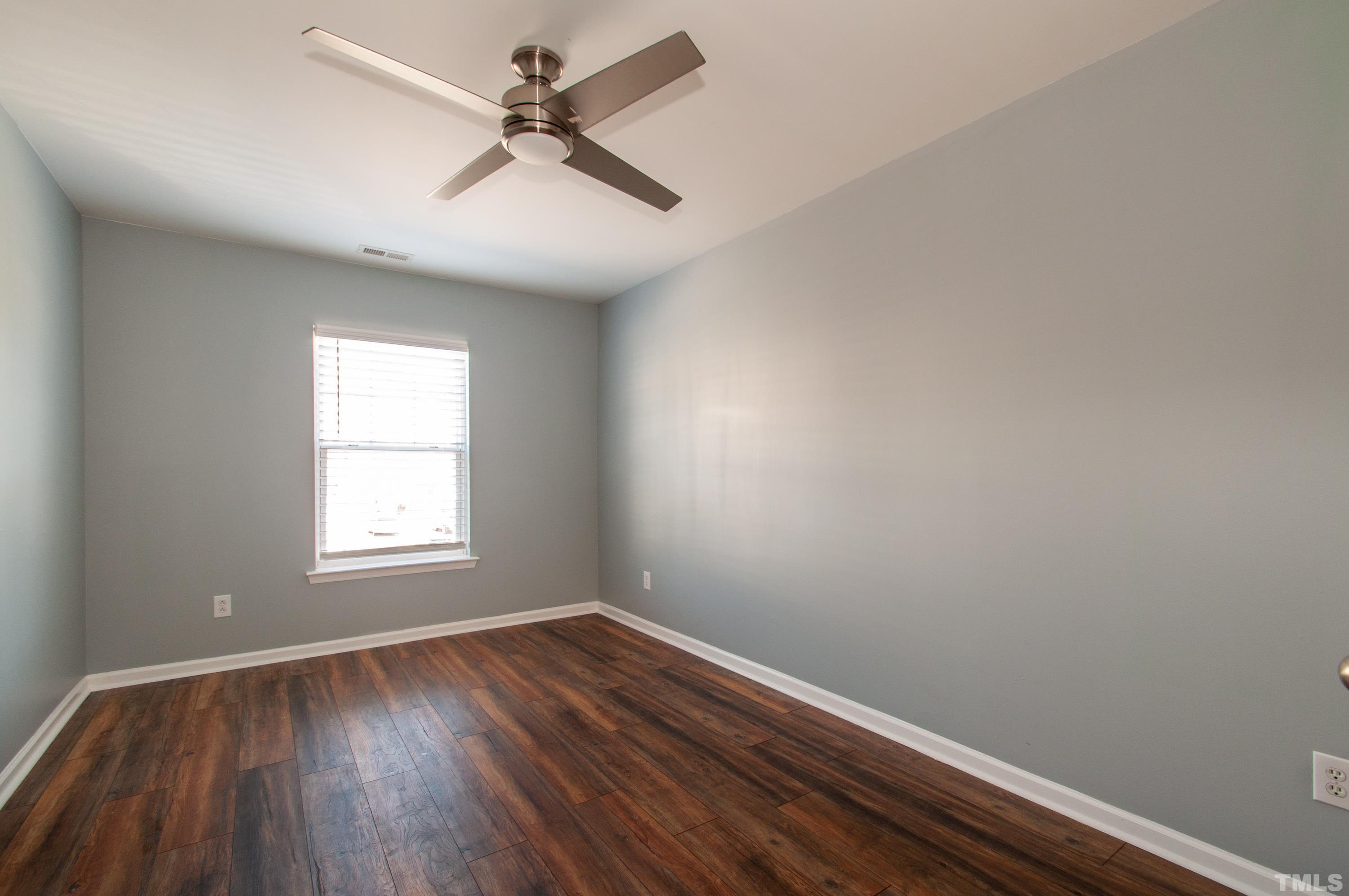 2210 Raven Road, Unit 102 Raleigh, NC 27614 - Photo 16 of 33 an empty room with a window and wooden floor