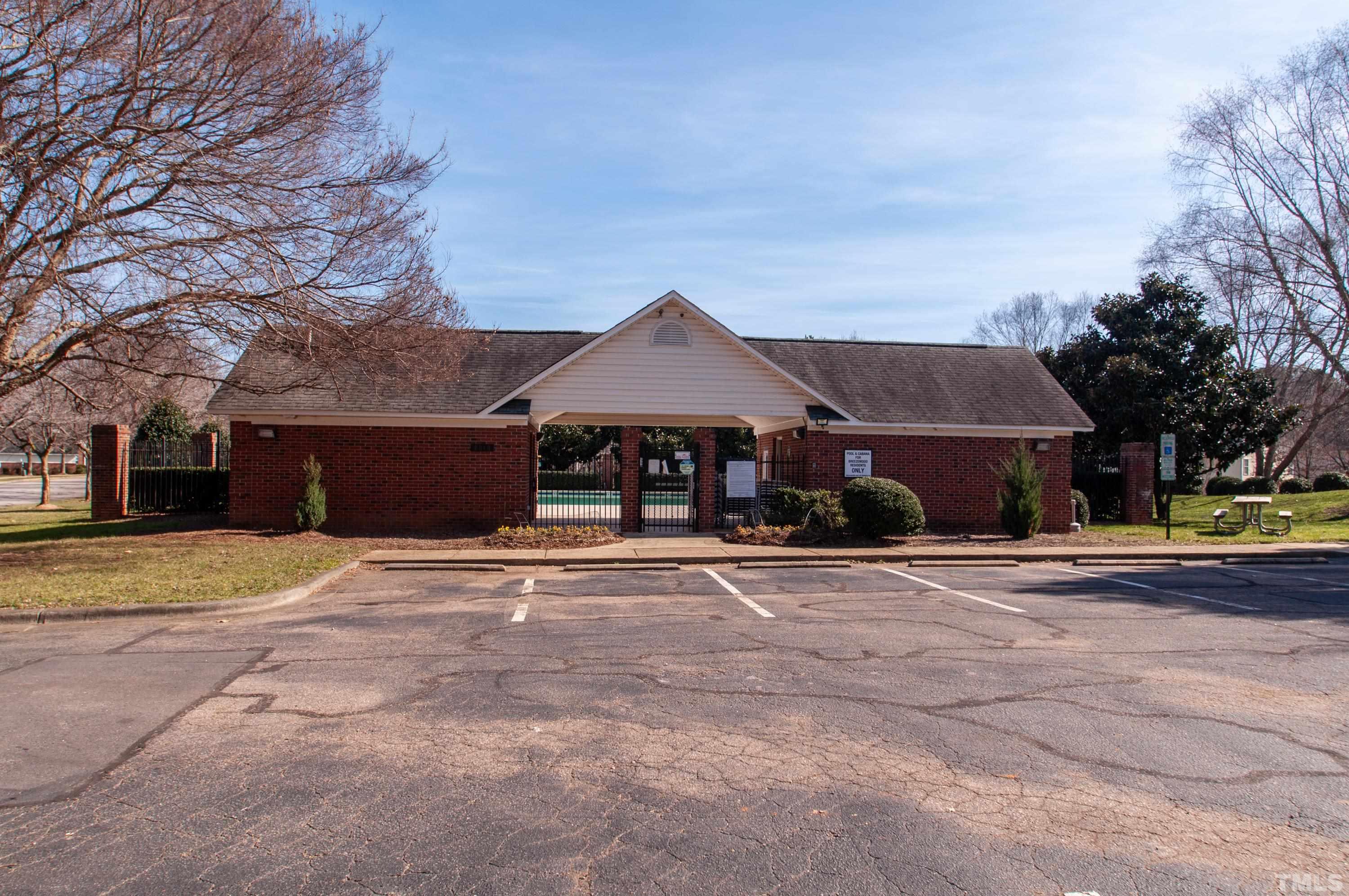 2210 Raven Road, Unit 102 Raleigh, NC 27614 - Photo 25 of 33 a front view of a house with a yard and garage