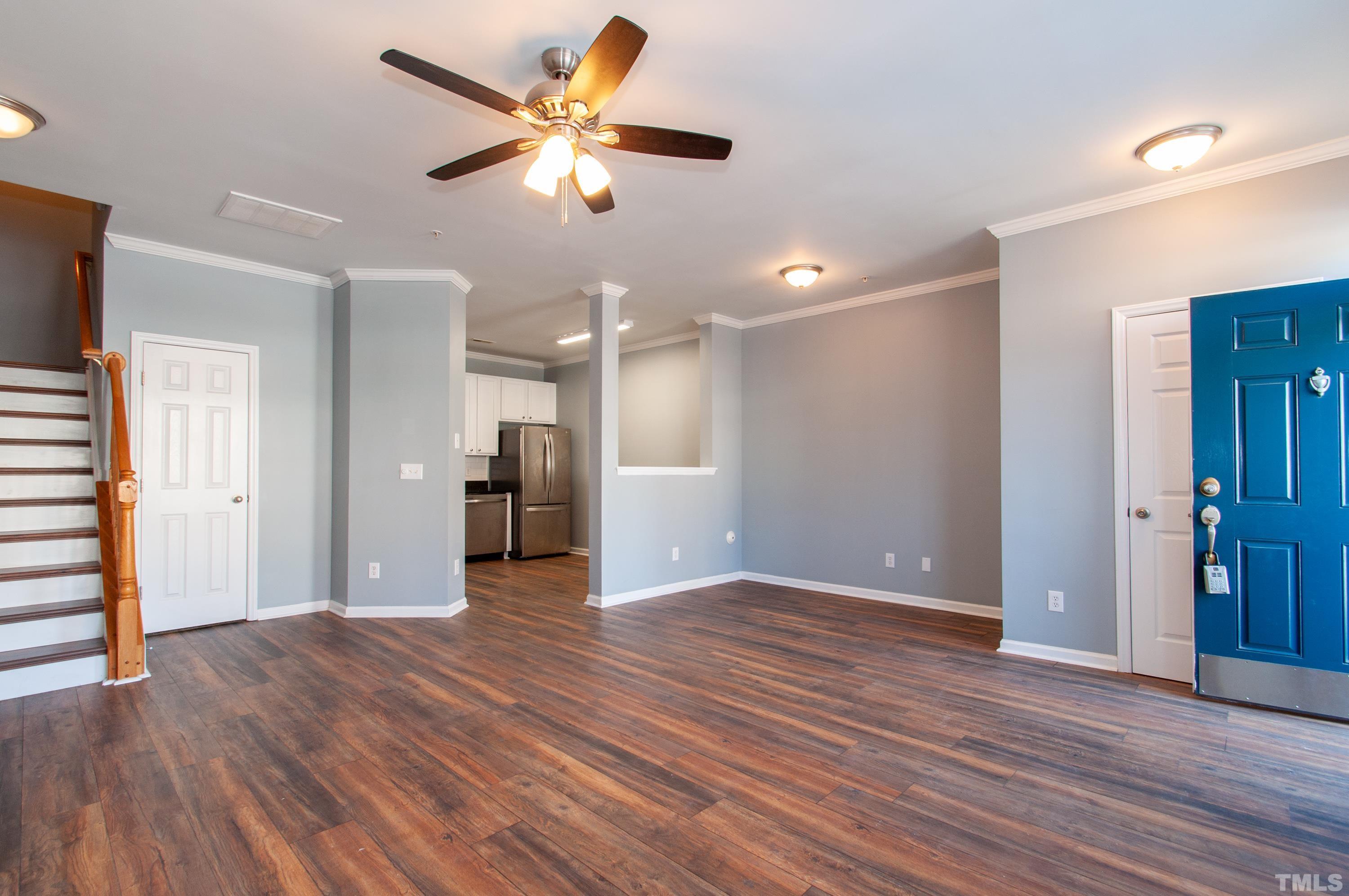 2210 Raven Road, Unit 102 Raleigh, NC 27614 - Photo 4 of 33 an empty room with wooden floor and a ceiling fan