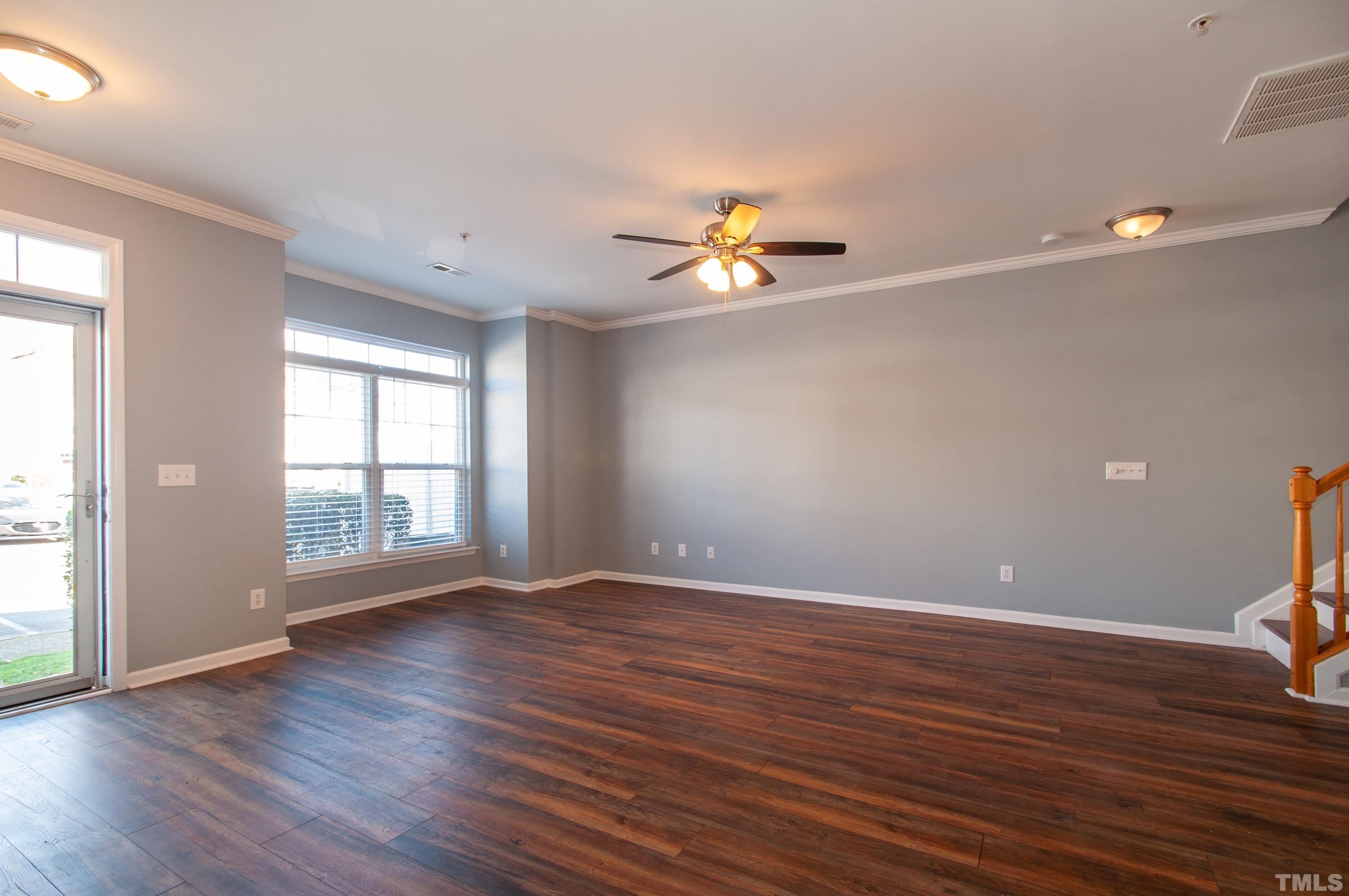 2210 Raven Road, Unit 102 Raleigh, NC 27614 - Photo 7 of 33 a view of an empty room with window and wooden floor