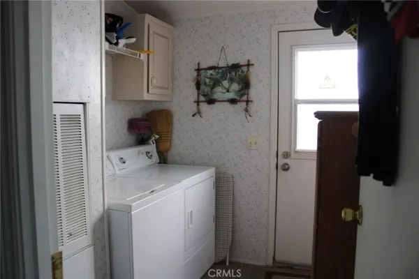 a bedroom with a bed a window and potted plants