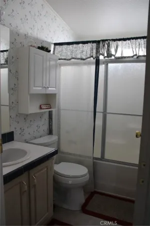 a bedroom with a bed and dresser