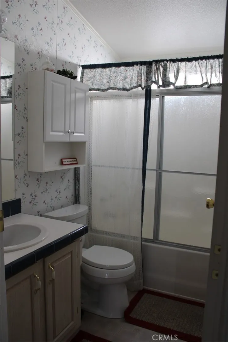 2 Havasu Lake Road Needles, CA 92363 - Photo 16 of 24 a bathroom with a sink a toilet and shower