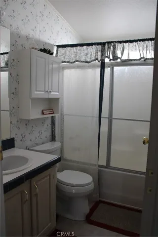 a bedroom with bed and wooden floor