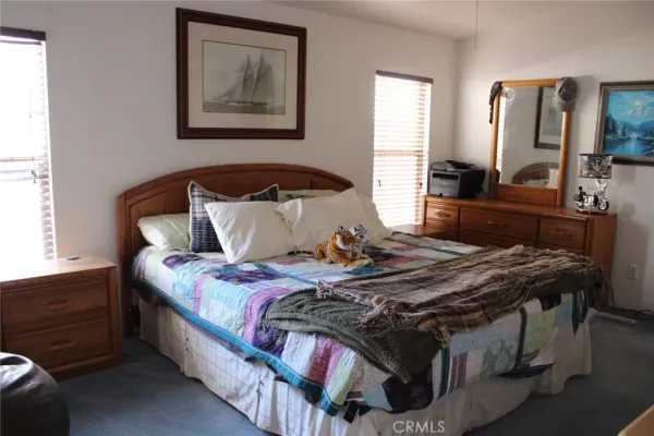 a bedroom with bed and a flat screen tv