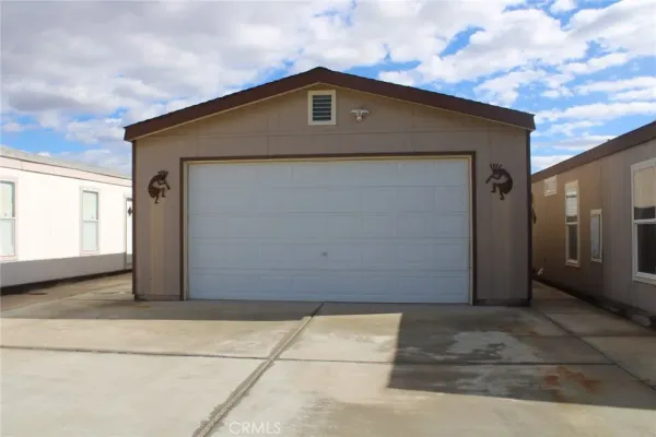 a kitchen with stainless steel appliances kitchen island granite countertop a table chairs in it and wooden floors