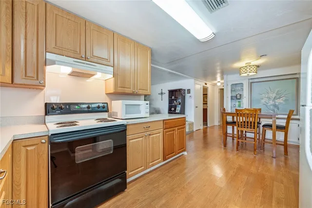 a kitchen with stainless steel appliances granite countertop a stove and a refrigerator