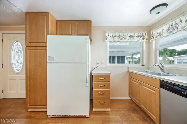 a kitchen with stainless steel appliances a refrigerator and a stove