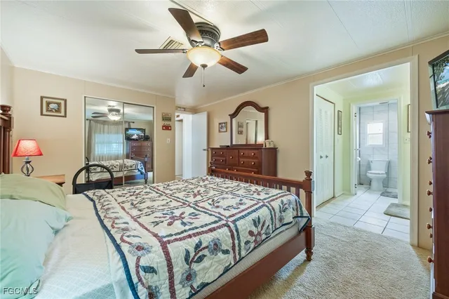 a bedroom with a bed and ceiling fan