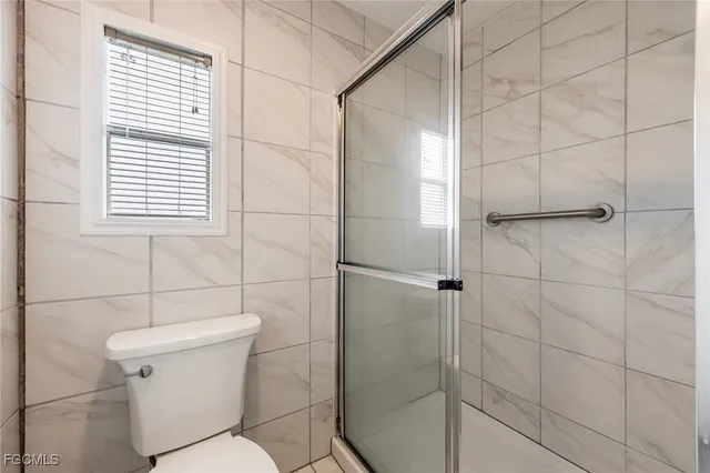 a white toilet sitting next to a bathroom sink