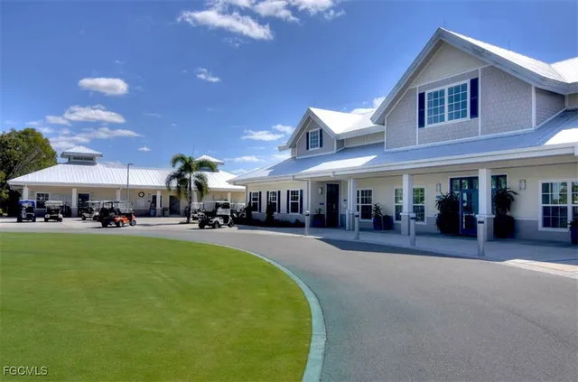 a view of a swimming pool with lawn chairs under an umbrella