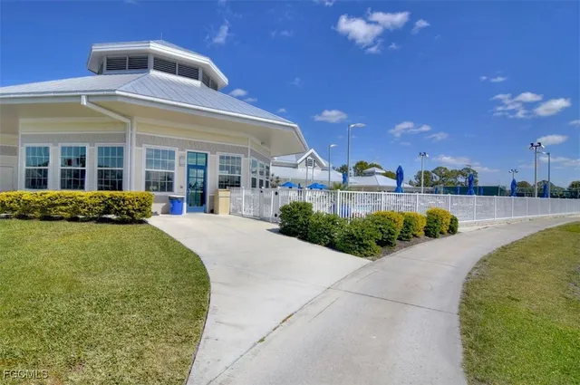 a front view of a house with a yard and potted plants