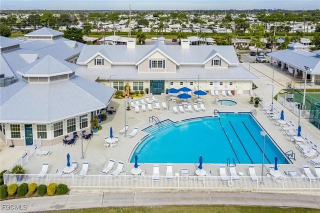 an aerial view of house with yard swimming pool and ocean view