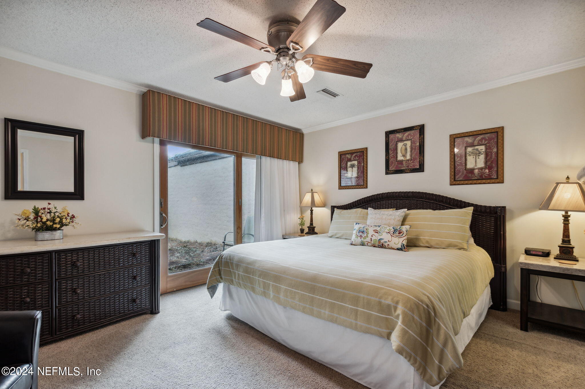 3327 Sea Marsh Road Fernandina Beach, FL 32034 - Photo 17 of 39 a bedroom with a large bed and a chandelier