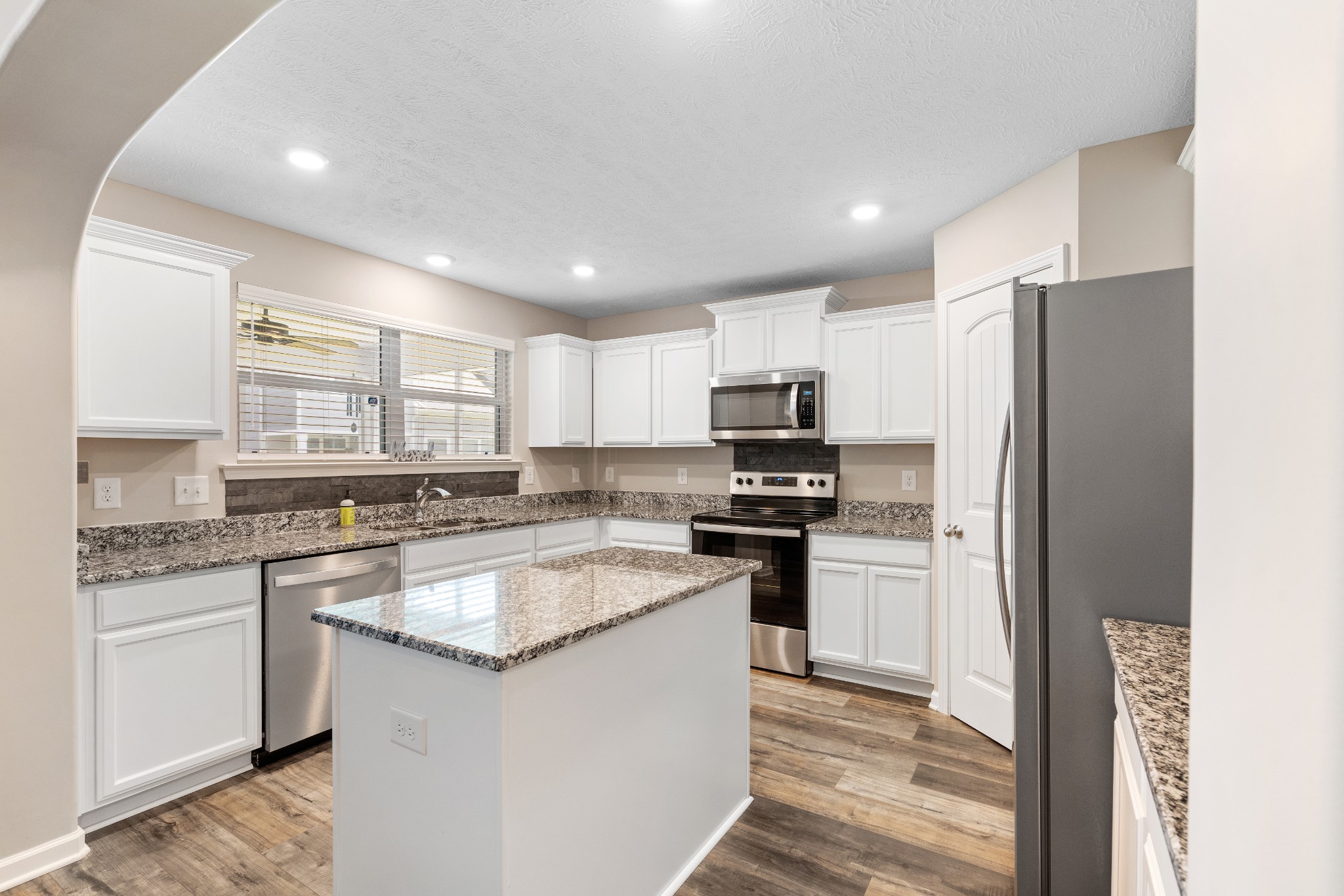 1626 Calcutta Drive Murfreesboro, TN 37128 - Photo 15 of 35 a kitchen with stainless steel appliances granite countertop a refrigerator stove microwave and sink