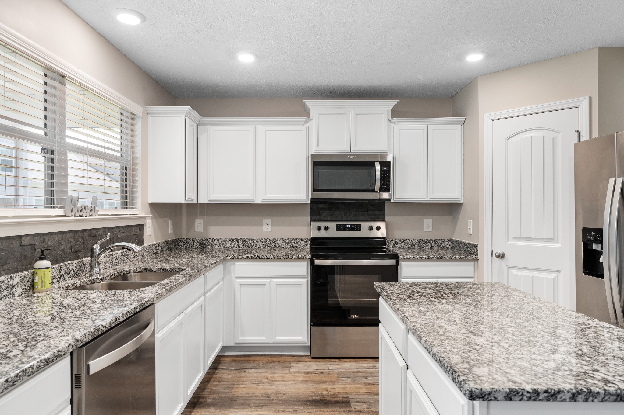 1626 Calcutta Drive Murfreesboro, TN 37128 - Photo 17 of 35 a kitchen with stainless steel appliances granite countertop a sink stove and refrigerator