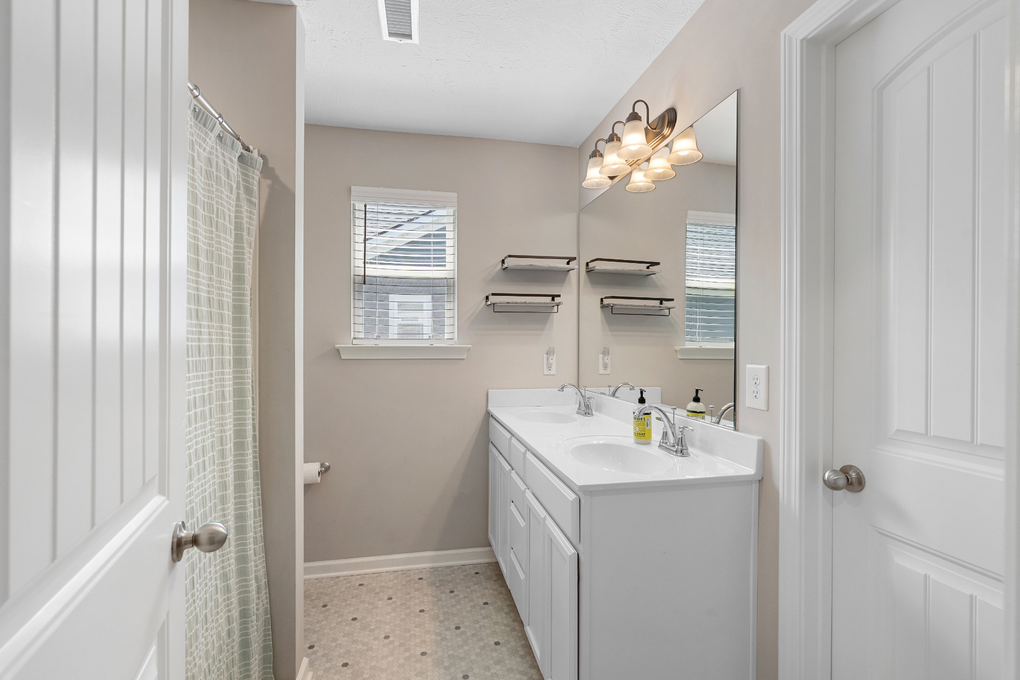 1626 Calcutta Drive Murfreesboro, TN 37128 - Photo 23 of 35 a bathroom with a sink a vanity and a mirror