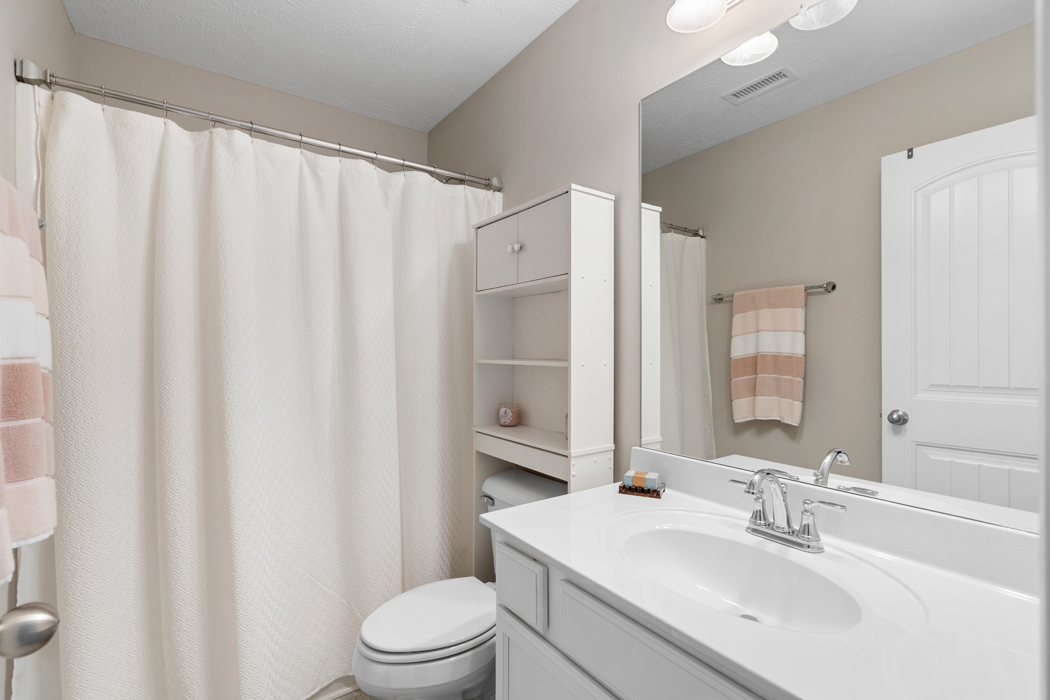 1626 Calcutta Drive Murfreesboro, TN 37128 - Photo 27 of 35 a bathroom with a sink a toilet and shower curtain