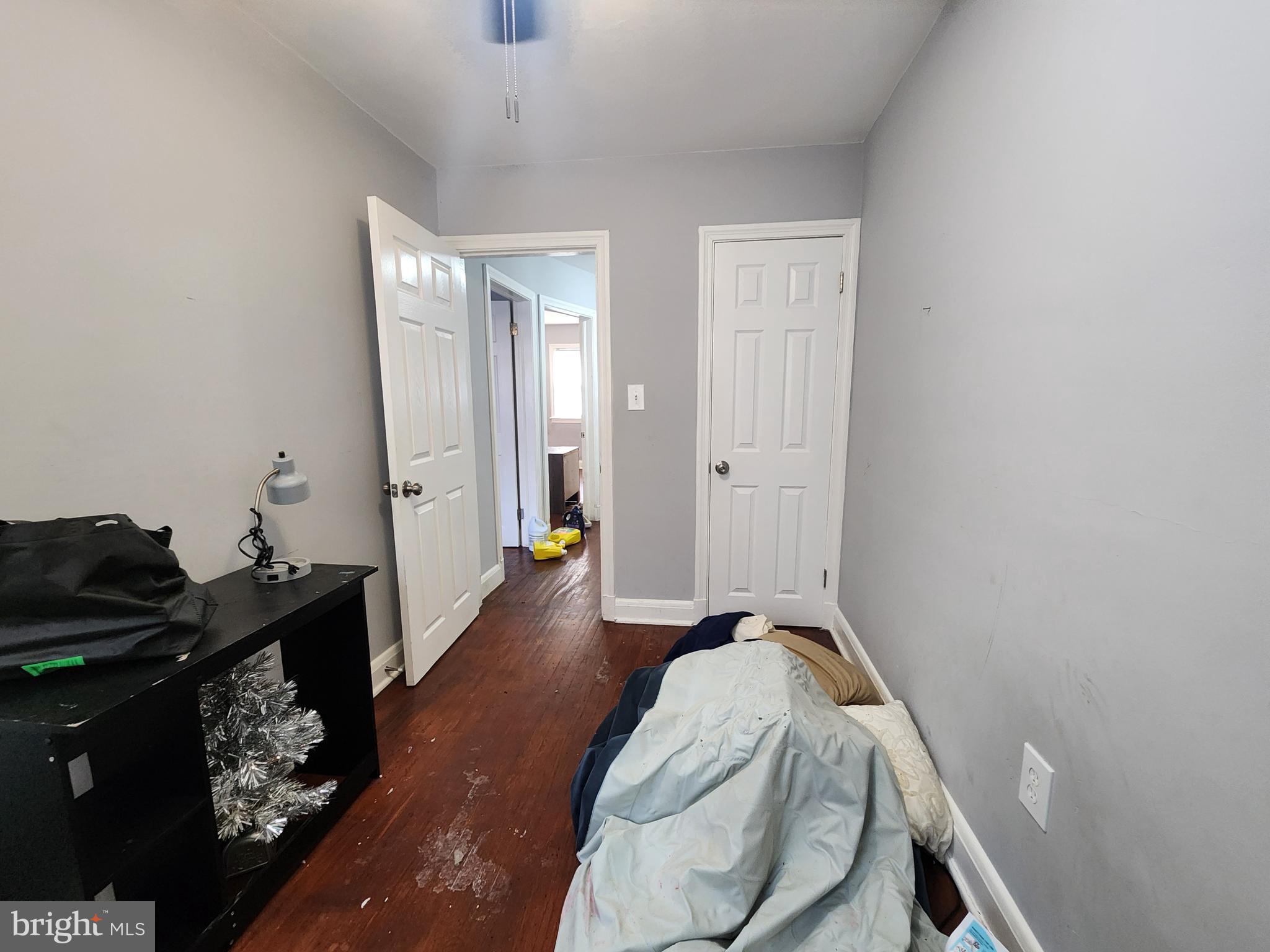 1310 Edison Highway Baltimore, MD 21213 - Photo 19 of 31 a bedroom with a bed and wooden floor