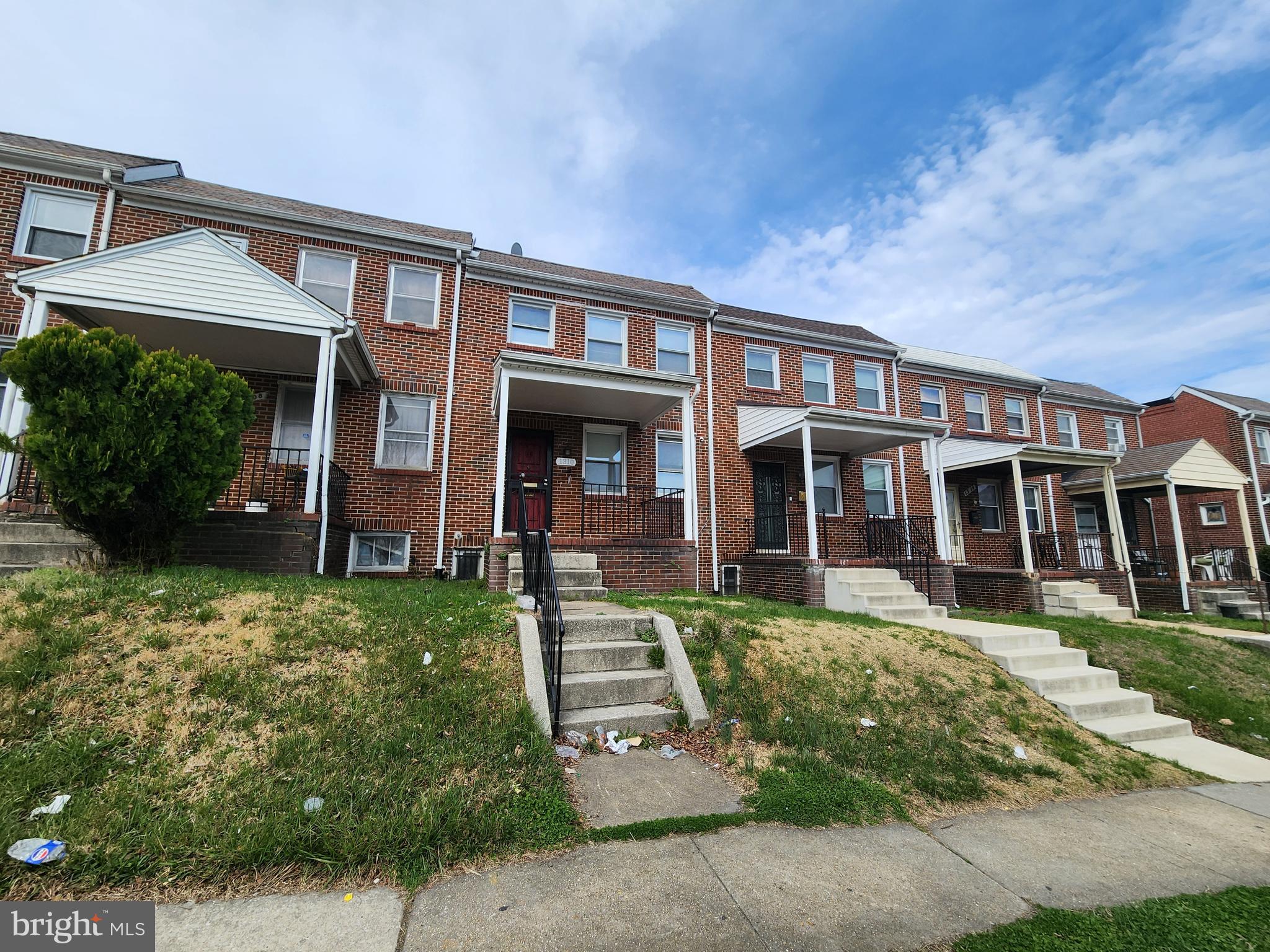 1310 Edison Highway Baltimore, MD 21213 - Photo 2 of 31 front view of a brick house with a yard