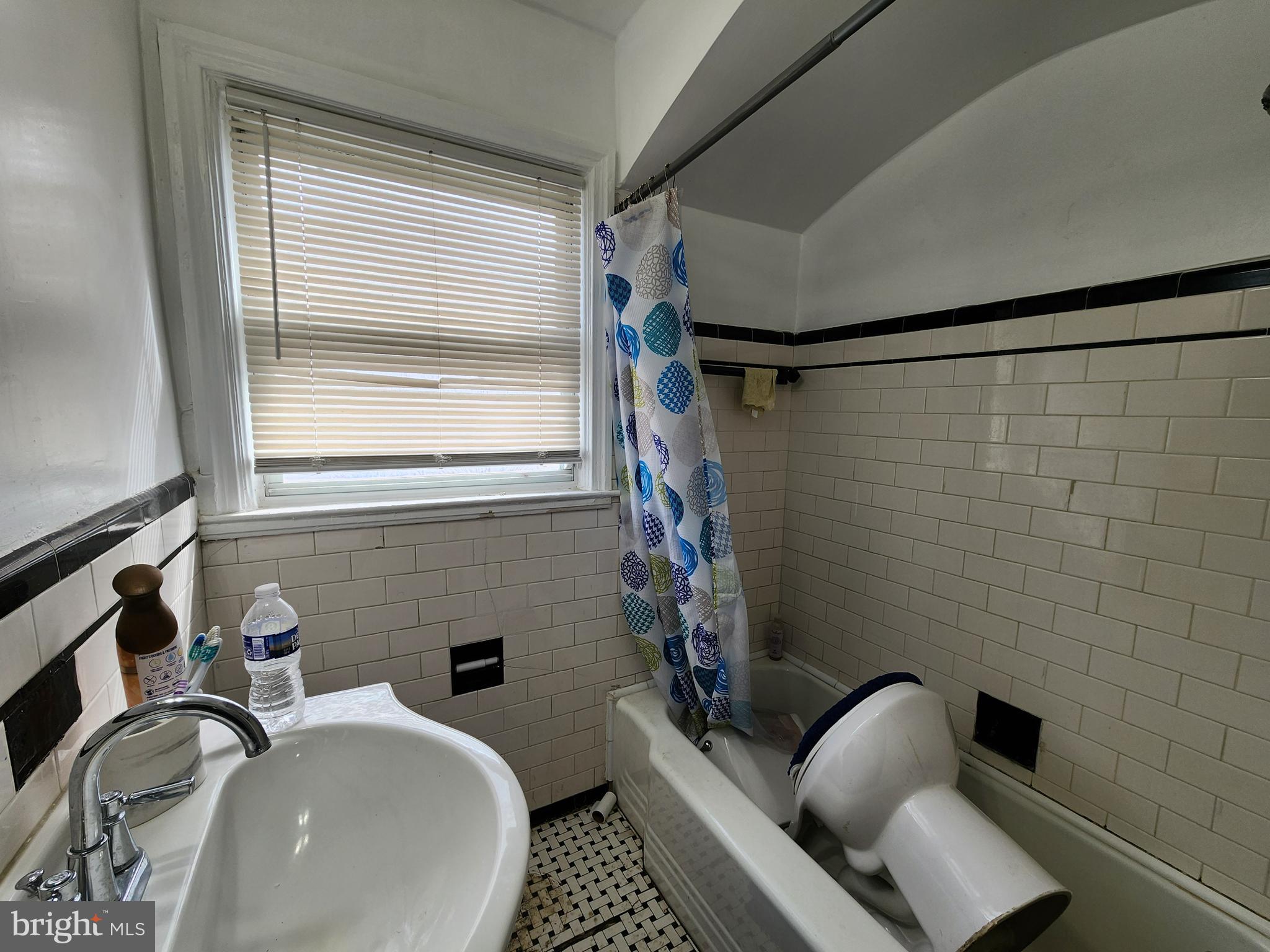 1310 Edison Highway Baltimore, MD 21213 - Photo 26 of 31 a bathroom with a sink a toilet a mirror and shower