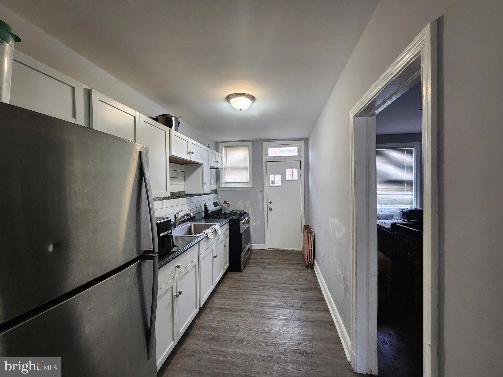 1310 Edison Highway Baltimore, MD 21213 - Photo 5 of 31 a kitchen with stainless steel appliances a refrigerator and a stove