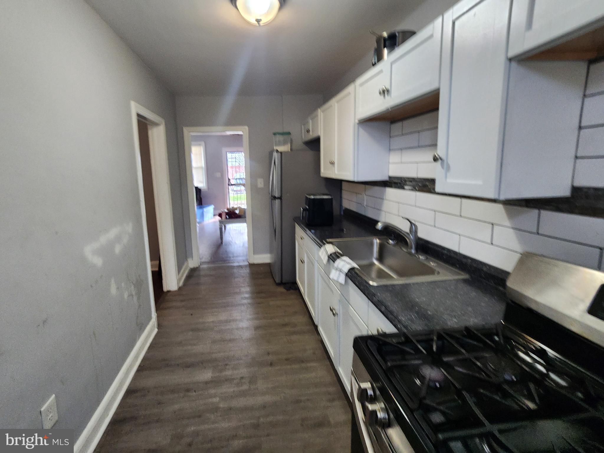 1310 Edison Highway Baltimore, MD 21213 - Photo 9 of 31 a kitchen with sink stove and cabinets