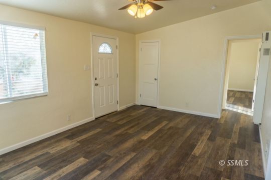 309 North Florence Street Ridgecrest, CA 93555 - Photo 7 of 31 a view of an empty room with wooden floor and a window