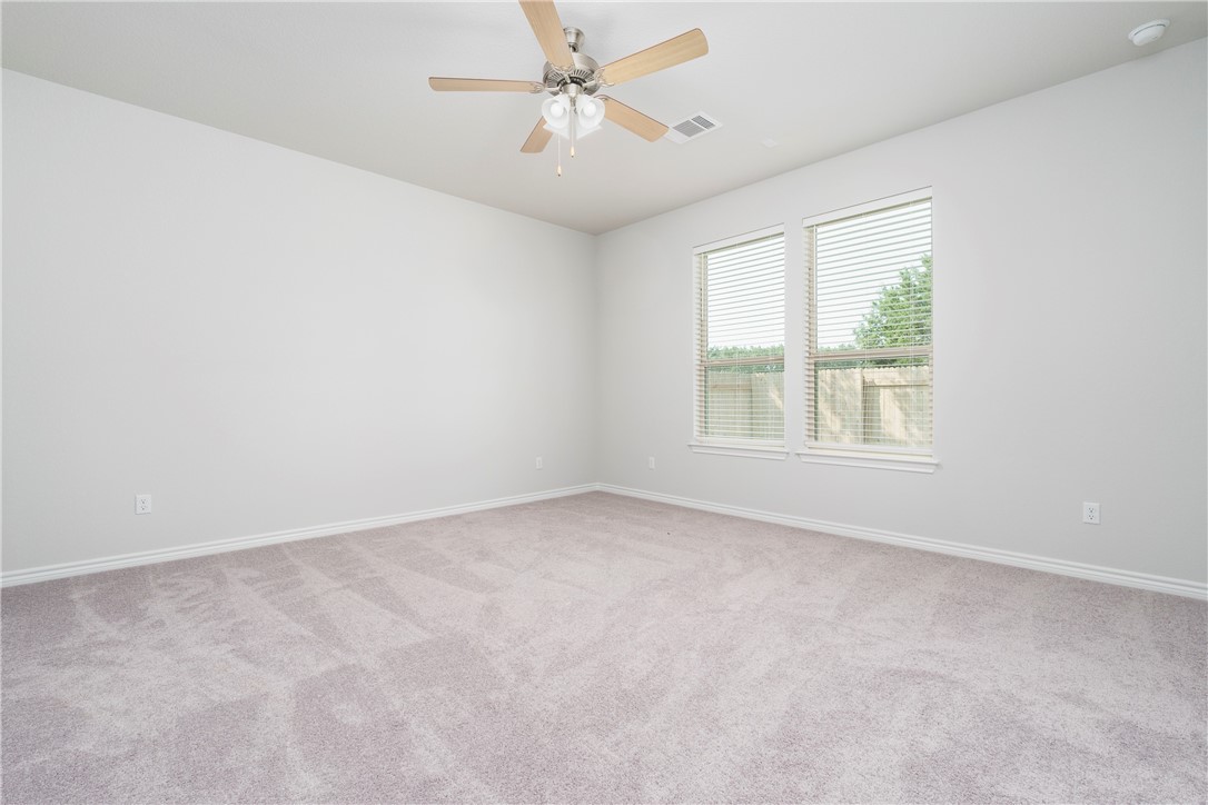 1613 Winding Stream Trail, Unit 75 Leander, TX 78641 - Photo 15 of 23 an empty room with a window and a ceiling fan