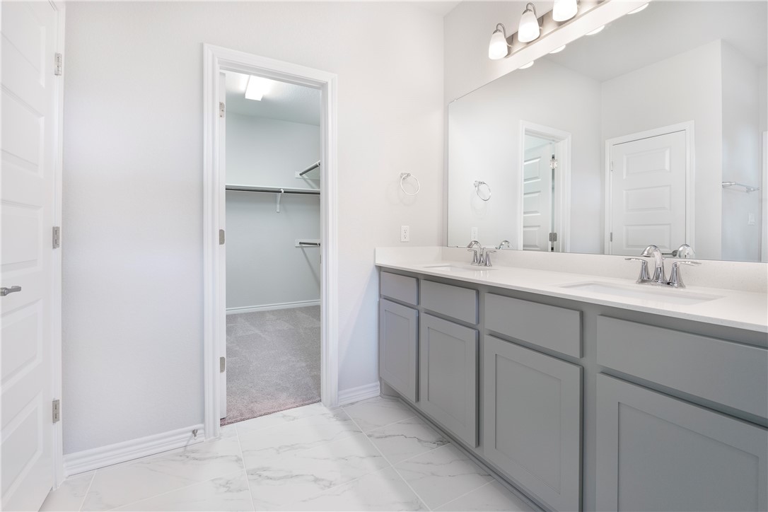1613 Winding Stream Trail, Unit 75 Leander, TX 78641 - Photo 18 of 23 a spacious bathroom with a double vanity sink a mirror and a shower