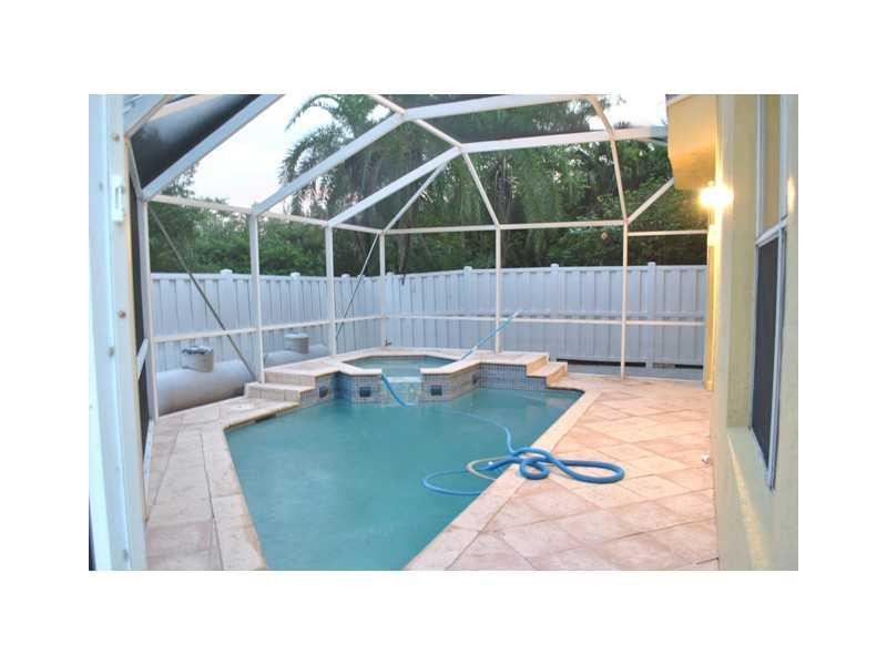 720 Natures Cove Road Dania Beach, FL 33004 - Photo 17 of 17 a backyard of a house with table and chairs