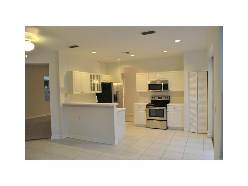 720 Natures Cove Road Dania Beach, FL 33004 - Photo 4 of 17 a open kitchen with cabinets and stainless steel appliances