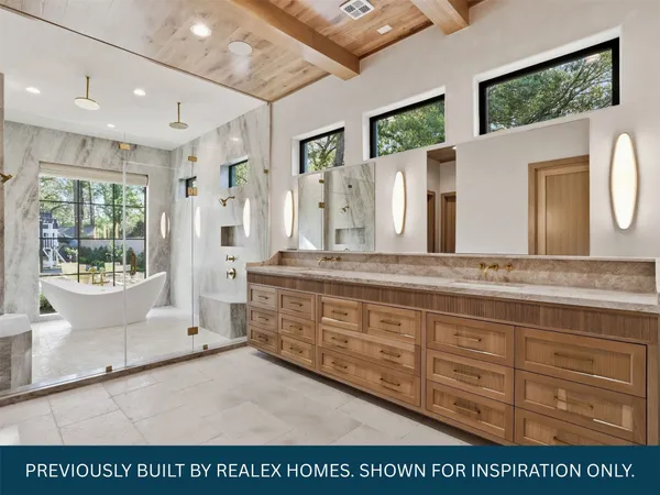 a spacious bathroom with a granite countertop sink mirror and a bath tub