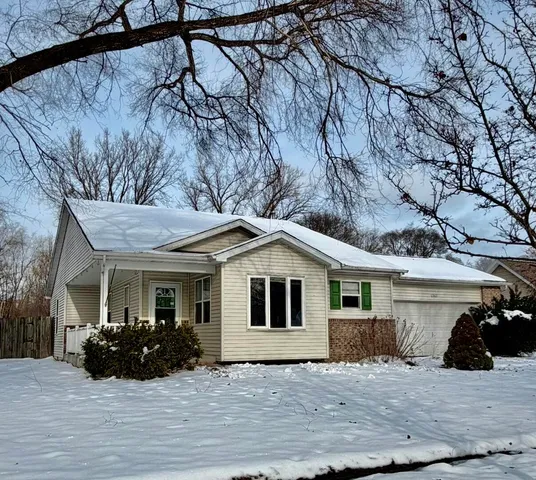 a view of a house with a snow in the background