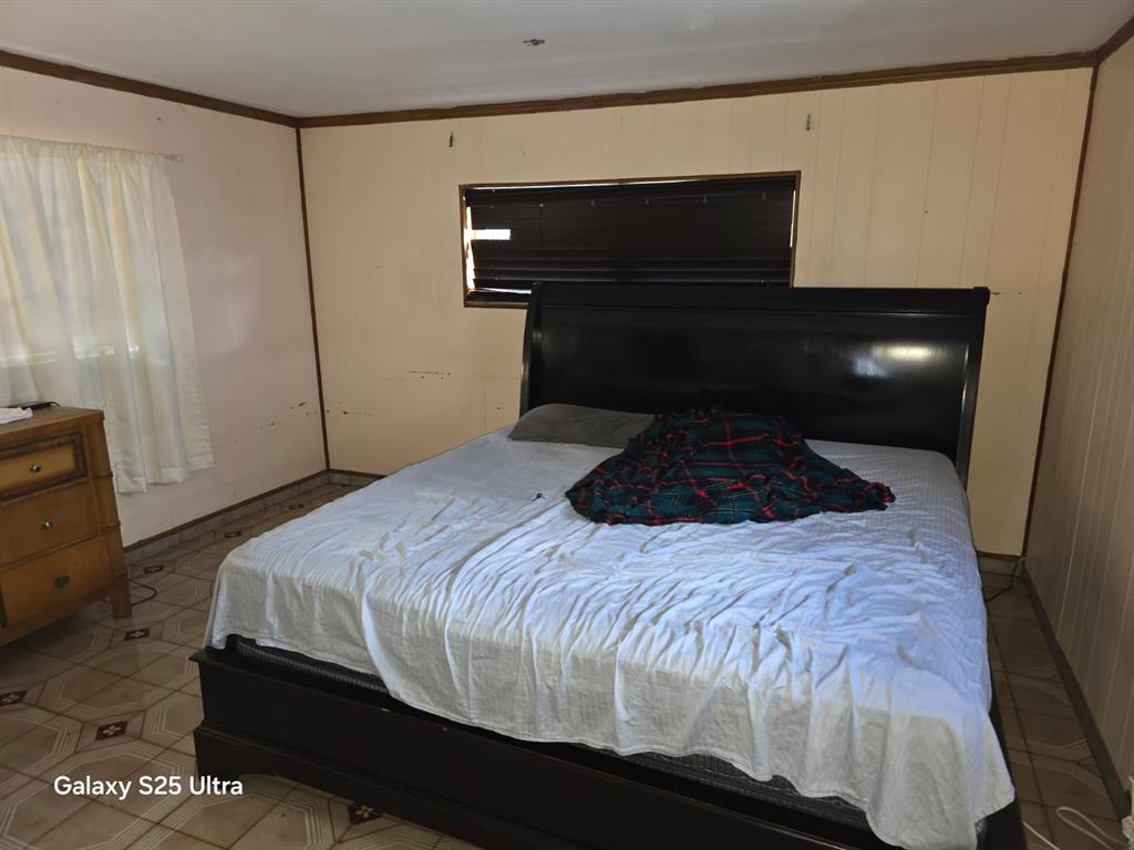 446 Northwest 119th Street Miami, FL 33168 - Photo 11 of 14 a bedroom with a bed and a mirror