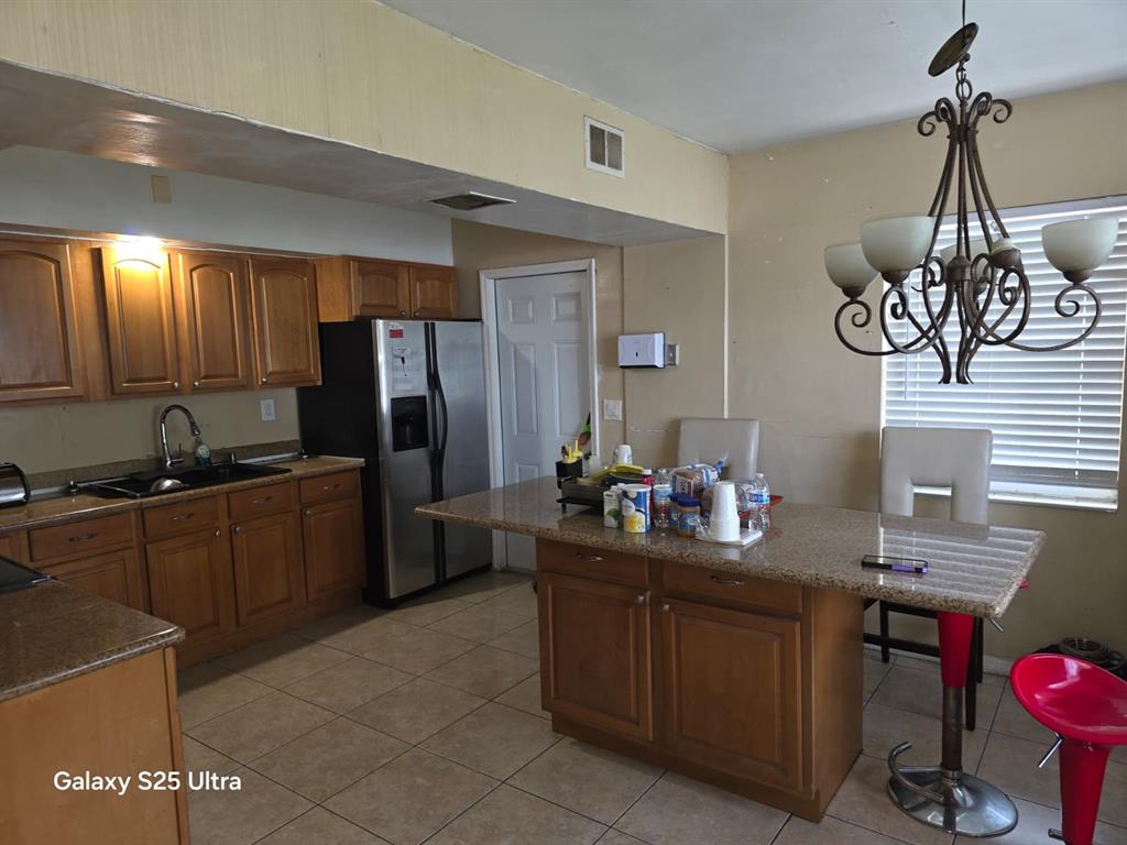 446 Northwest 119th Street Miami, FL 33168 - Photo 5 of 14 a kitchen with a refrigerator and a sink