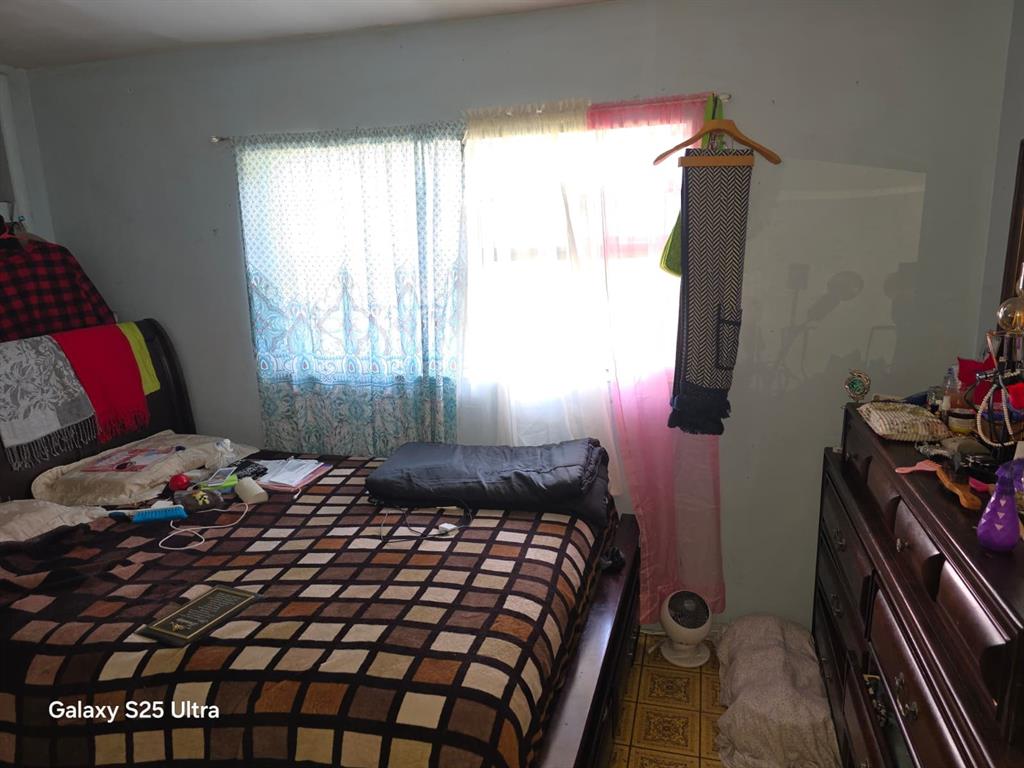 446 Northwest 119th Street Miami, FL 33168 - Photo 8 of 14 a bedroom with a bed and a window