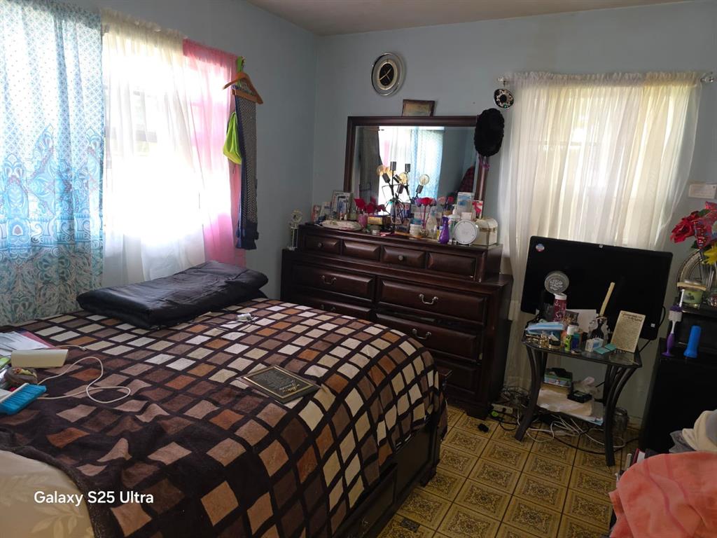 446 Northwest 119th Street Miami, FL 33168 - Photo 9 of 14 a bedroom with a bed and window