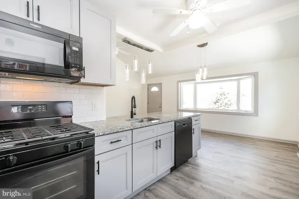 a kitchen with stainless steel appliances a stove microwave and cabinets