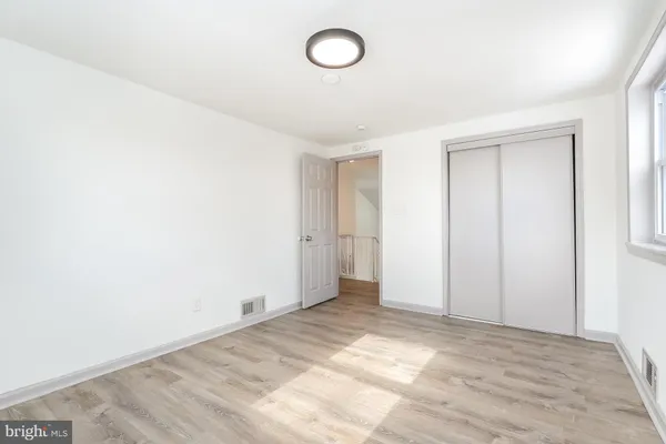 a view of a room with wooden floor and bathroom