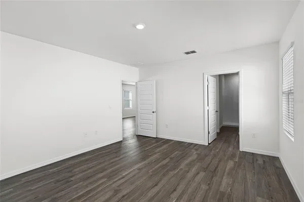 a view of a room with wooden floor