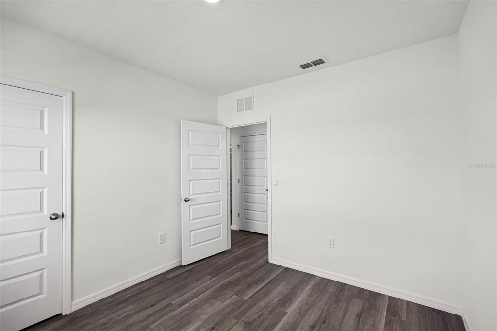 1726 Hummingbird Road Winter Haven, FL 33884 - Photo 19 of 28 wooden floor in an empty room
