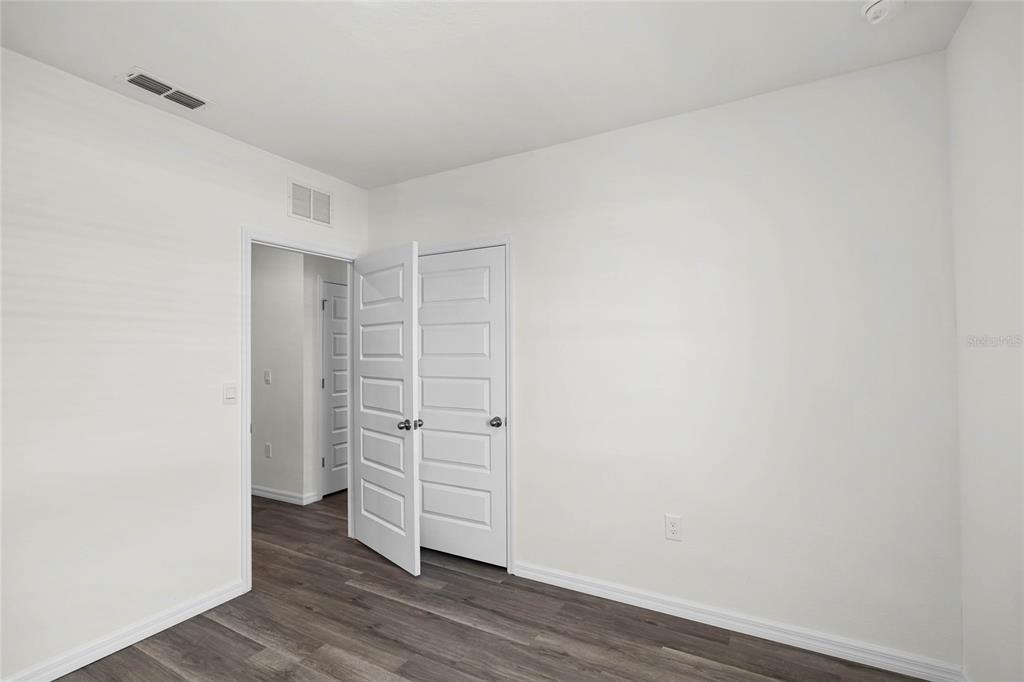 1726 Hummingbird Road Winter Haven, FL 33884 - Photo 23 of 28 a view of walk in closet with empty racks