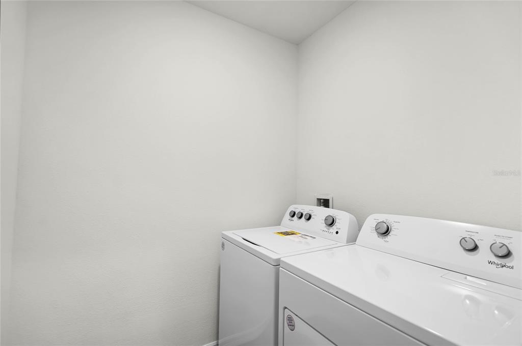 1726 Hummingbird Road Winter Haven, FL 33884 - Photo 27 of 28 a utility room with dryer and washer